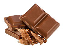 Pieces of milk chocolate bars stacked on top of each other with chocolate shavings in front